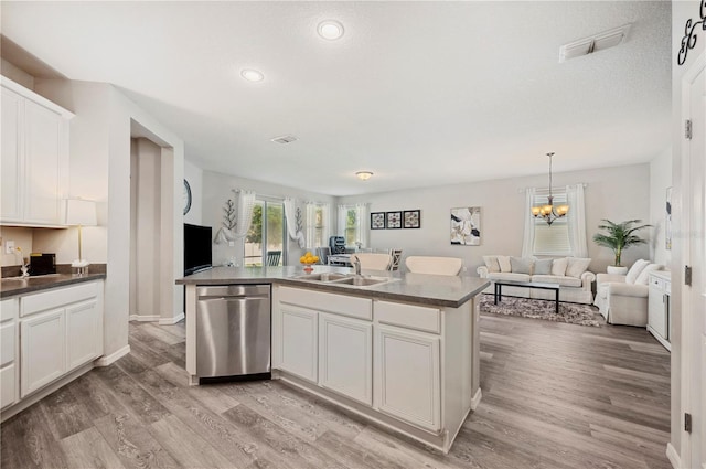 4303 Moon Shadow Loop, Mulberry, FL 33860 - kitchen with stainless steel dishwasher, open floor plan, dark countertops, a sink, and recessed lighting