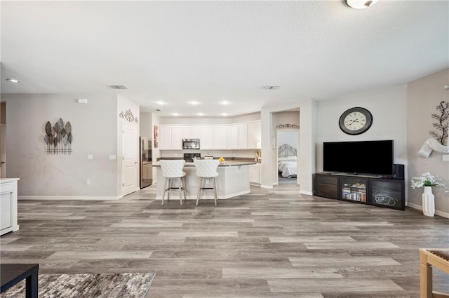 4303 Moon Shadow Loop, Mulberry, FL 33860 - living room featuring light wood finished floors, baseboards, and recessed lighting