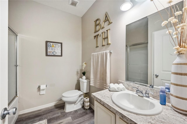 4303 Moon Shadow Loop, Mulberry, FL 33860 - full bath featuring wood finished floors, toilet, vanity, and a shower with door
