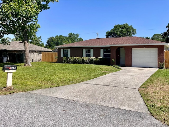 2323 Ridgeview Dr, Lakeland, FL 33810 - ranch-style house featuring a garage, concrete driveway, brick siding, and roof with shingles