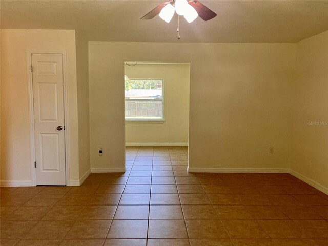 2323 Ridgeview Dr, Lakeland, FL 33810 - spare room featuring light tile patterned floors, a ceiling fan, and baseboards