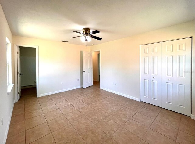 2323 Ridgeview Dr, Lakeland, FL 33810 - unfurnished bedroom with baseboards, a closet, tile patterned flooring, and a ceiling fan