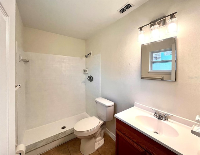 2323 Ridgeview Dr, Lakeland, FL 33810 - bathroom featuring toilet, tile patterned flooring, a tile shower, and vanity