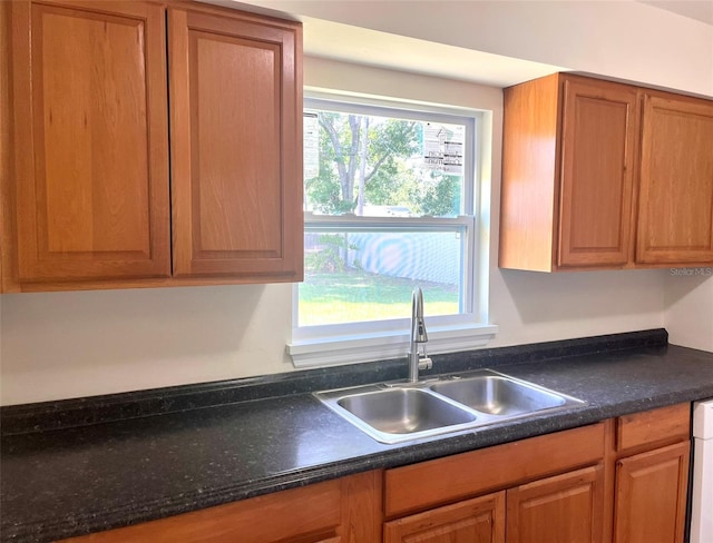 2323 Ridgeview Dr, Lakeland, FL 33810 - kitchen featuring a sink, healthy amount of natural light, dark countertops, and brown cabinets