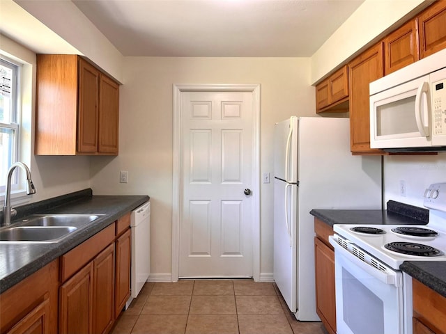 2323 Ridgeview Dr, Lakeland, FL 33810 - kitchen with white appliances, a sink, brown cabinets, and dark countertops