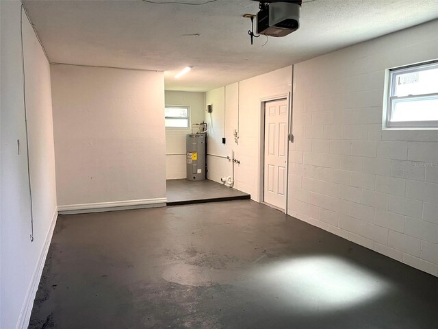 2323 Ridgeview Dr, Lakeland, FL 33810 - garage with a garage door opener, concrete block wall, and water heater