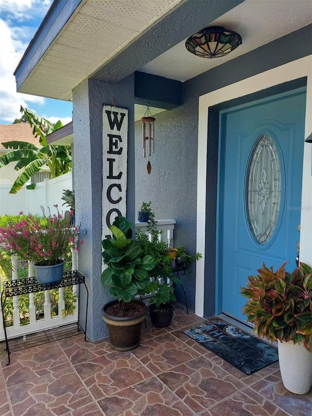 455 Eagle Dr, Kissimmee, FL 34759 - property entrance featuring a porch and stucco siding