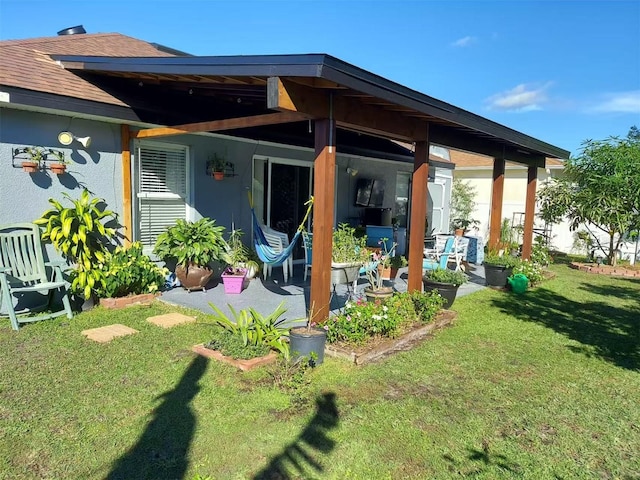 455 Eagle Dr, Kissimmee, FL 34759 - rear view of house with a lawn, a patio area, and roof with shingles