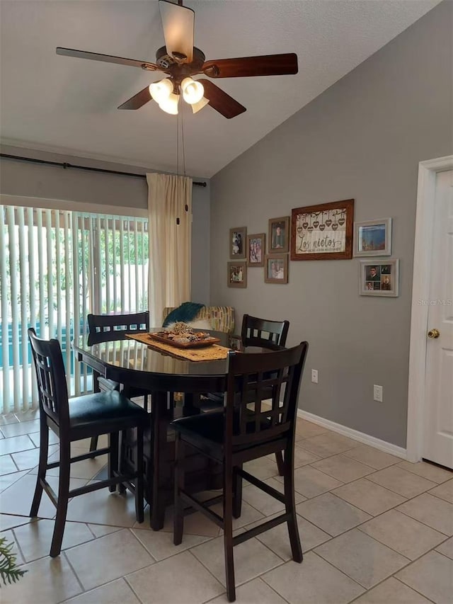 455 Eagle Dr, Kissimmee, FL 34759 - dining area with vaulted ceiling, ceiling fan, light tile patterned floors, and baseboards