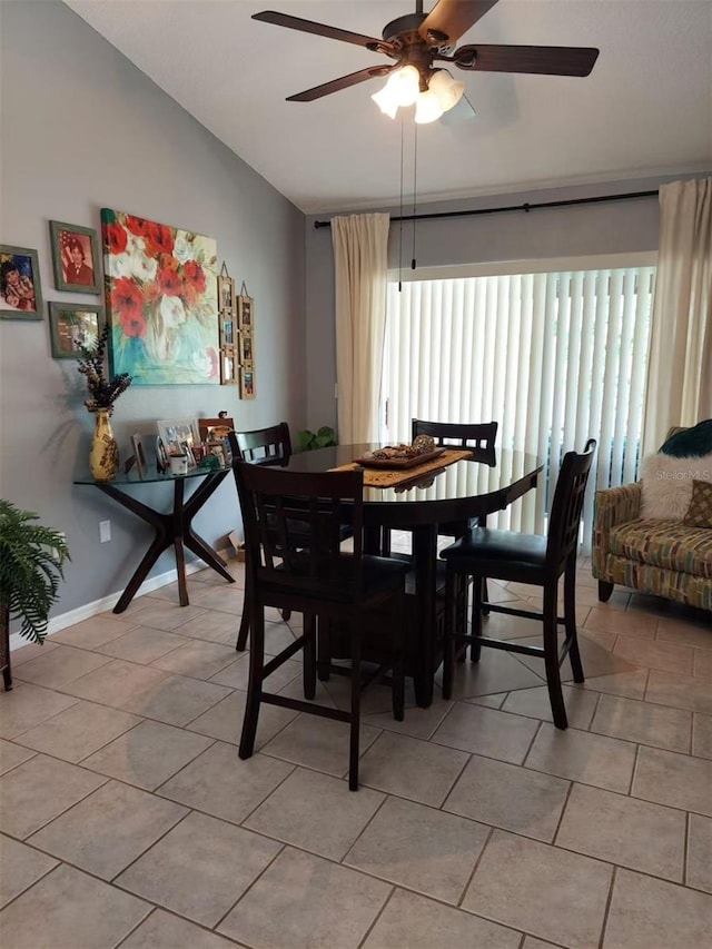 455 Eagle Dr, Kissimmee, FL 34759 - dining room featuring ceiling fan, lofted ceiling, light tile patterned floors, and baseboards