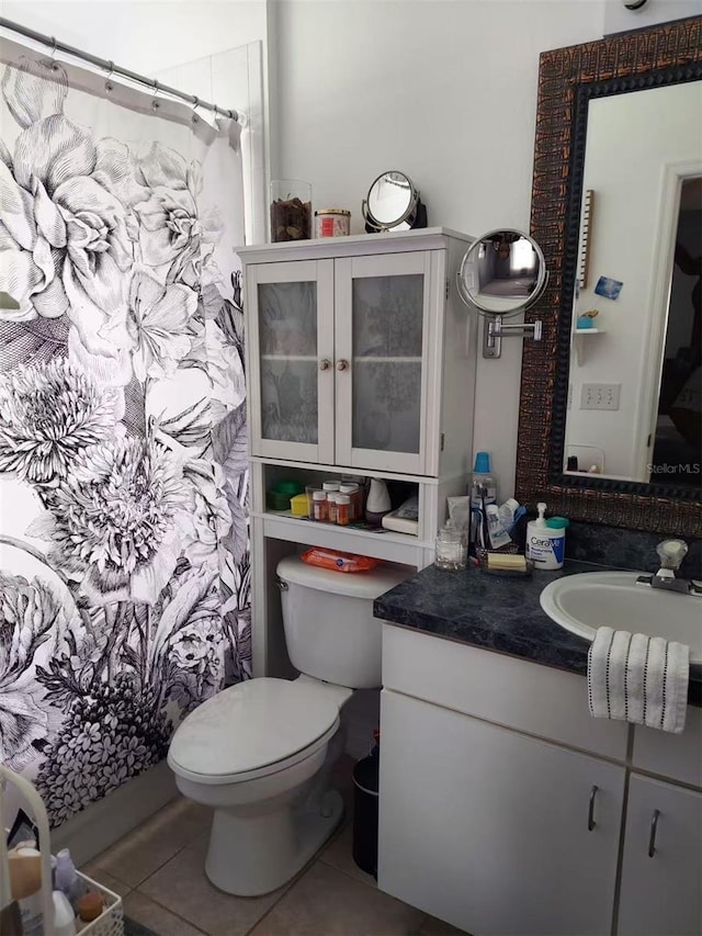 455 Eagle Dr, Kissimmee, FL 34759 - bathroom with tile patterned flooring, toilet, vanity, and a shower with shower curtain