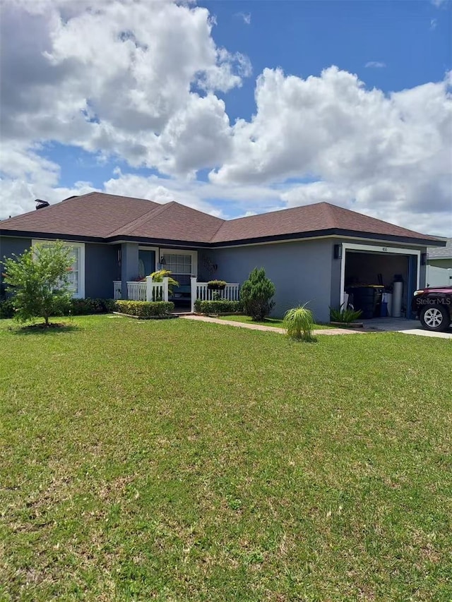 455 Eagle Dr, Kissimmee, FL 34759 - ranch-style house featuring an attached garage, a front yard, driveway, stucco siding, and covered porch