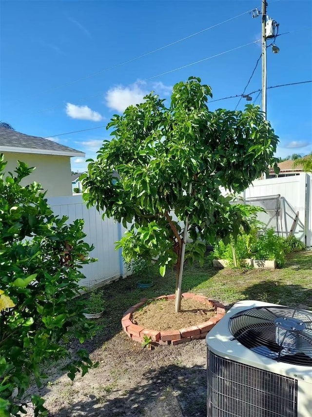 455 Eagle Dr, Kissimmee, FL 34759 - view of yard featuring cooling unit and fence
