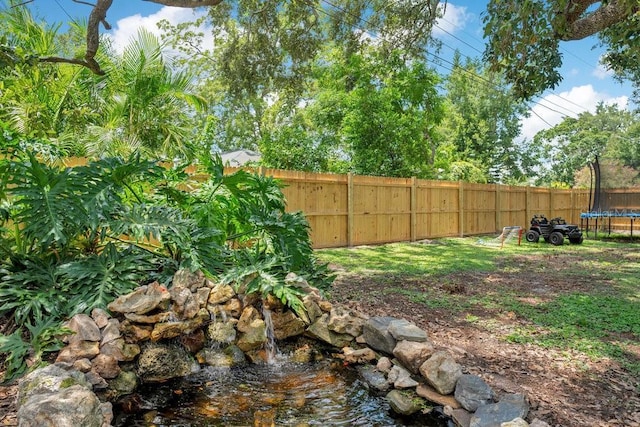 312 Palencia Pl, Lakeland, FL 33803 - fenced backyard featuring a trampoline