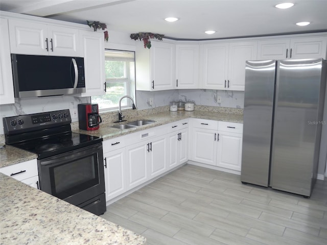 355 E Columbia St, Lake Alfred, FL 33850 - kitchen with appliances with stainless steel finishes, a sink, white cabinets, recessed lighting, and light wood finished floors