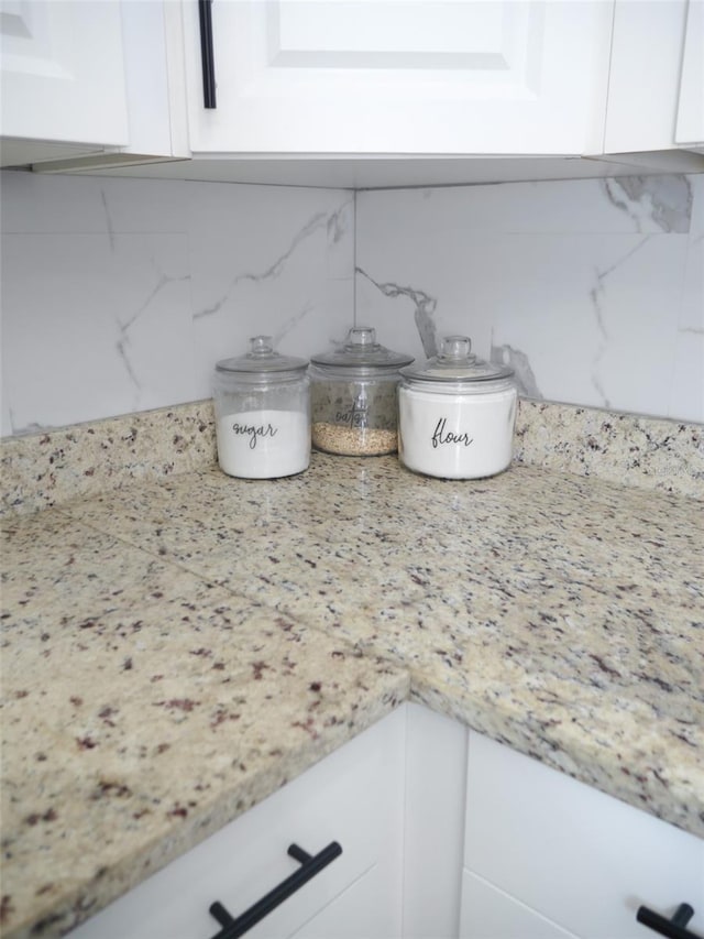 355 E Columbia St, Lake Alfred, FL 33850 - kitchen view of white cabinets, tasteful backsplash, and light stone countertops