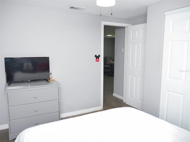 355 E Columbia St, Lake Alfred, FL 33850 - bedroom featuring baseboards and dark wood-type flooring