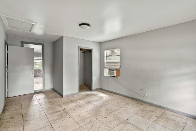 633 Glenda St, Lakeland, FL 33805 - unfurnished bedroom featuring multiple windows, attic access, a closet, and cooling unit