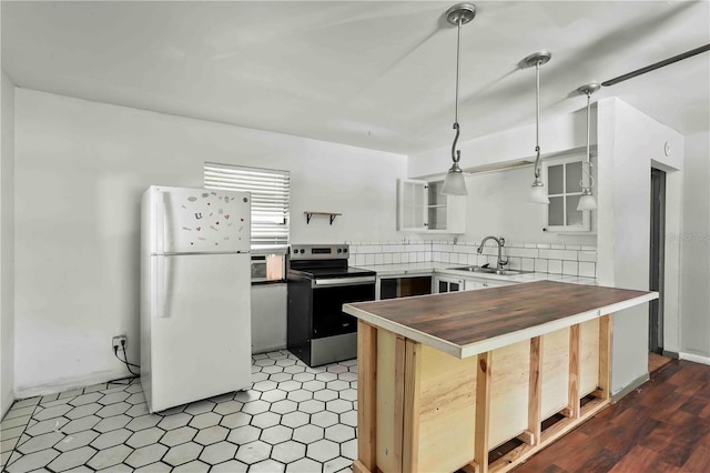633 Glenda St, Lakeland, FL 33805 - kitchen featuring freestanding refrigerator, stainless steel electric stove, a sink, glass insert cabinets, and pendant lighting