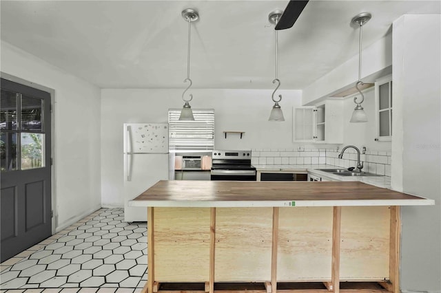 633 Glenda St, Lakeland, FL 33805 - kitchen featuring stainless steel range with electric stovetop, freestanding refrigerator, butcher block countertops, a sink, and a peninsula