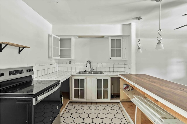 633 Glenda St, Lakeland, FL 33805 - kitchen with electric range, a sink, light countertops, glass insert cabinets, and backsplash