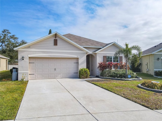 ranch-style house with driveway, a garage, a front yard, and stucco siding
