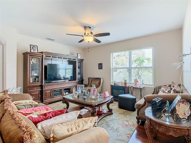living room featuring ceiling fan and wood finished floors