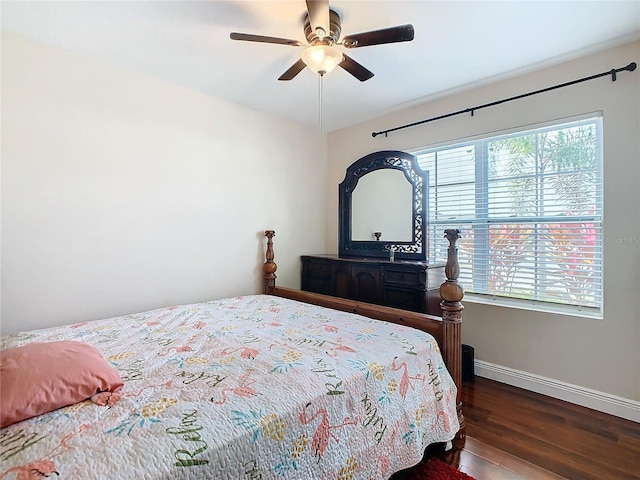 bedroom with baseboards, wood finished floors, and a ceiling fan