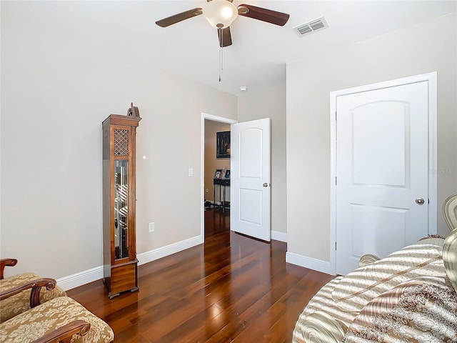 bedroom with wood finished floors, baseboards, and a ceiling fan