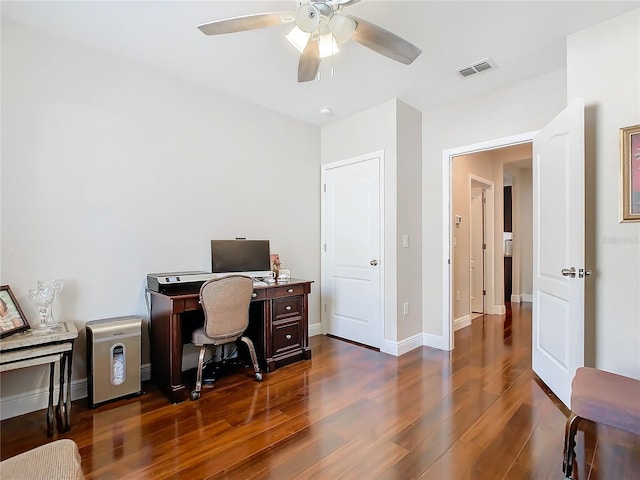 home office featuring dark wood finished floors, ceiling fan, and baseboards