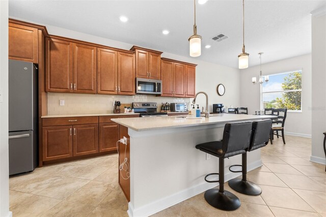 3136 Langdon Ln, Winter Haven, FL 33884 - kitchen with stainless steel appliances, a sink, backsplash, brown cabinetry, and light countertops