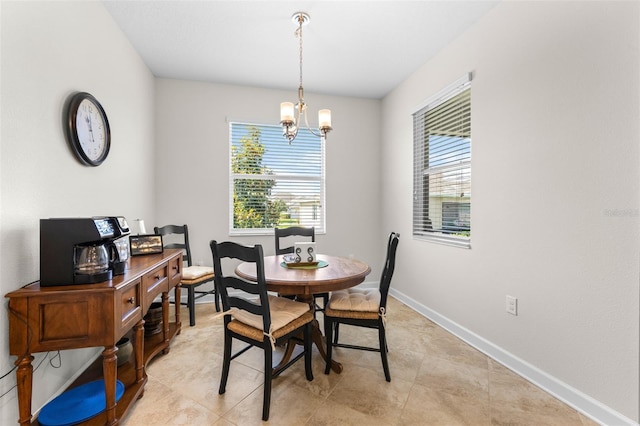 3136 Langdon Ln, Winter Haven, FL 33884 - dining area featuring healthy amount of natural light, a chandelier, and baseboards