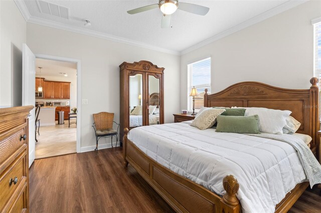 3136 Langdon Ln, Winter Haven, FL 33884 - bedroom with crown molding, wood finished floors, ceiling fan, and baseboards