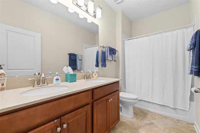 3136 Langdon Ln, Winter Haven, FL 33884 - bathroom featuring double vanity, toilet, tile patterned floors, and shower / bath combo