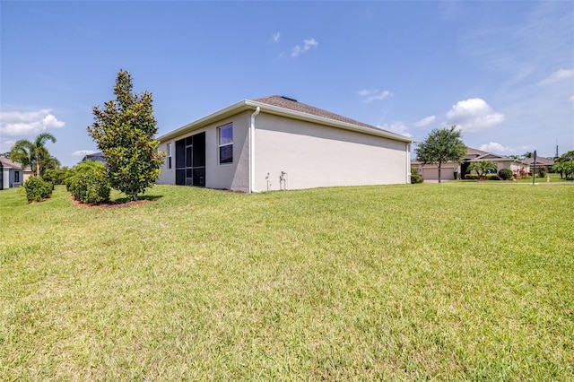 3136 Langdon Ln, Winter Haven, FL 33884 - back of house with stucco siding and a yard