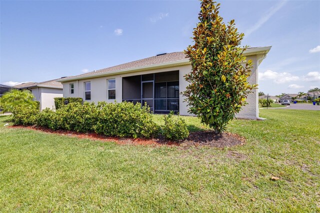 3136 Langdon Ln, Winter Haven, FL 33884 - back of property featuring stucco siding and a yard
