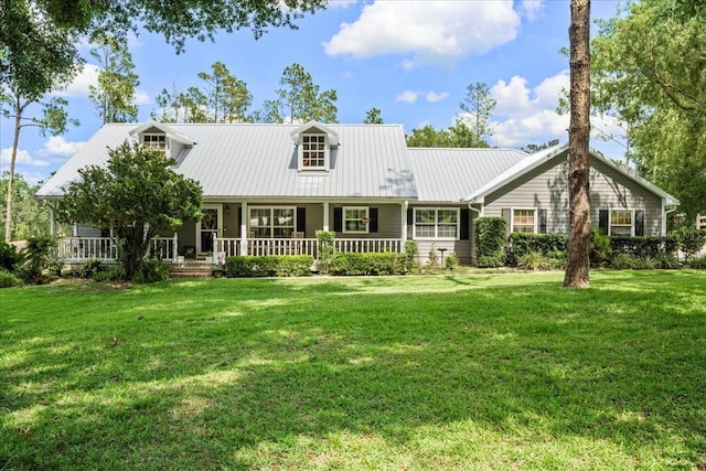 9912 Pine Leaf Ln, Dade City, FL 33525 - view of front facade featuring a porch, a front yard, and metal roof