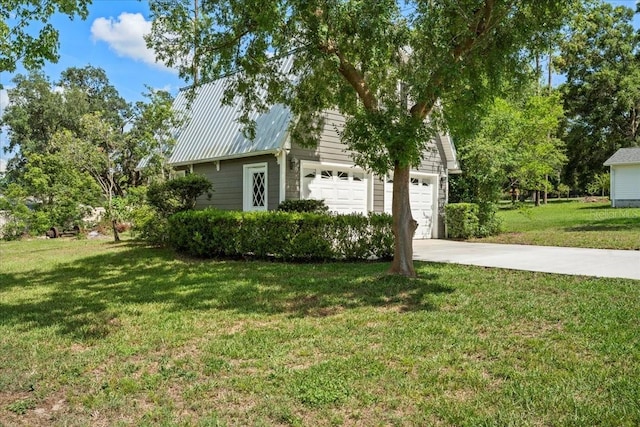 9912 Pine Leaf Ln, Dade City, FL 33525 - view of side of home featuring a garage, a lawn, driveway, and metal roof