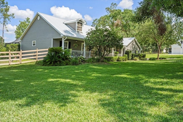 9912 Pine Leaf Ln, Dade City, FL 33525 - rear view of property featuring covered porch and metal roof
