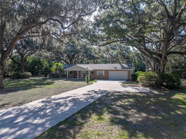 ranch-style house with concrete driveway, an attached garage, covered porch, a front lawn, and brick siding