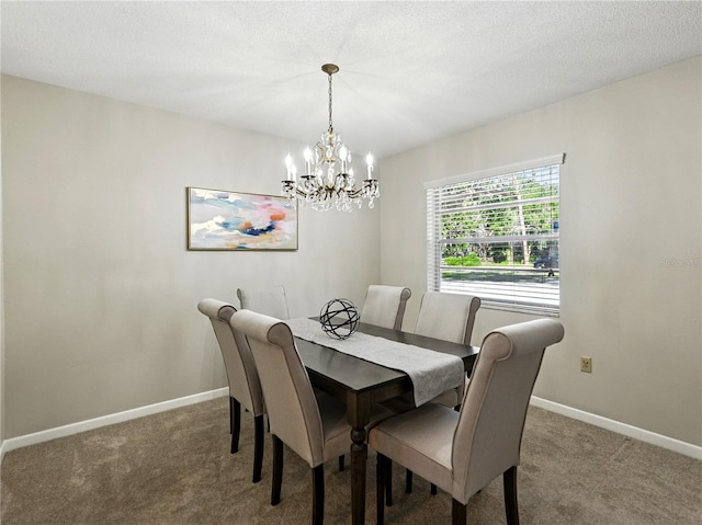 carpeted dining space with a chandelier and baseboards