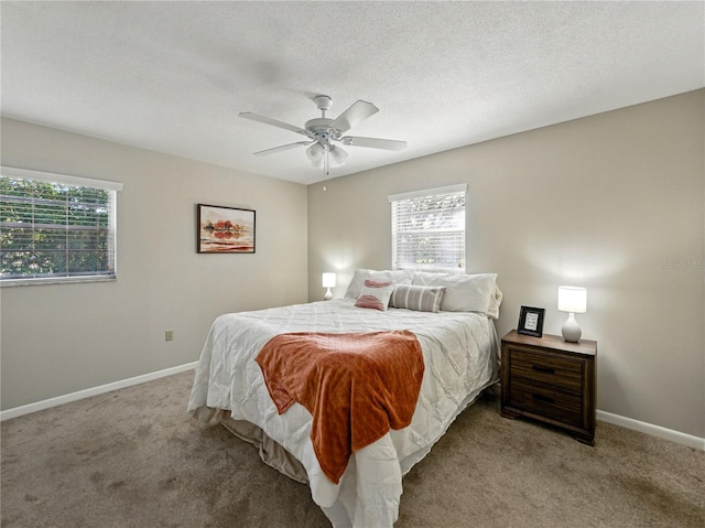 carpeted bedroom featuring baseboards, a ceiling fan, and a textured ceiling