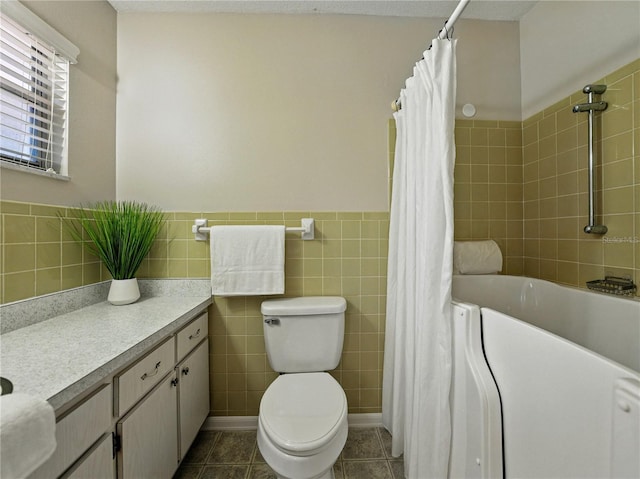 bathroom featuring vanity, toilet, a shower with curtain, a tub, and tile walls