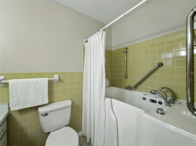 bathroom featuring tile walls, a bathtub, toilet, curtained shower, and vanity