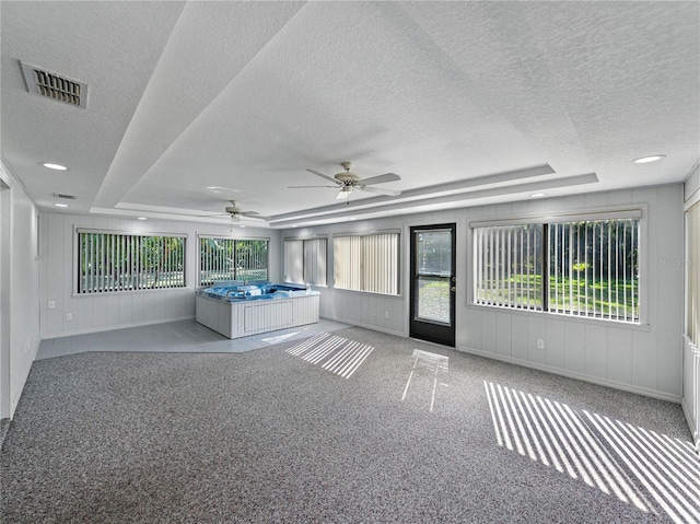 unfurnished sunroom with ceiling fan and healthy amount of natural light