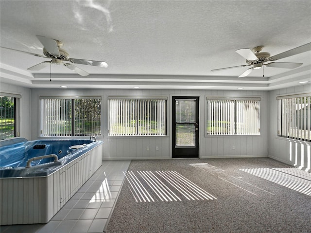 unfurnished sunroom with a hot tub
