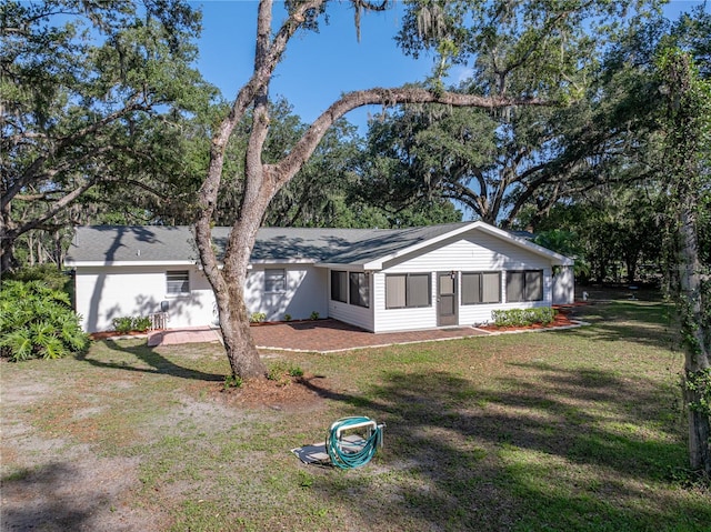 ranch-style house with a sunroom and a front yard