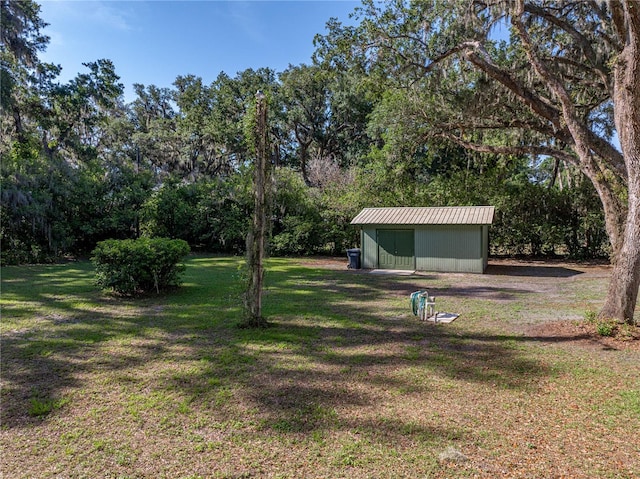 view of green lawn with an outdoor structure