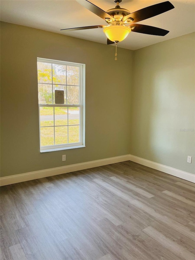 1329 Tom Watson Rd, Lakeland, FL 33801 - unfurnished room with wood finished floors, a ceiling fan, and baseboards