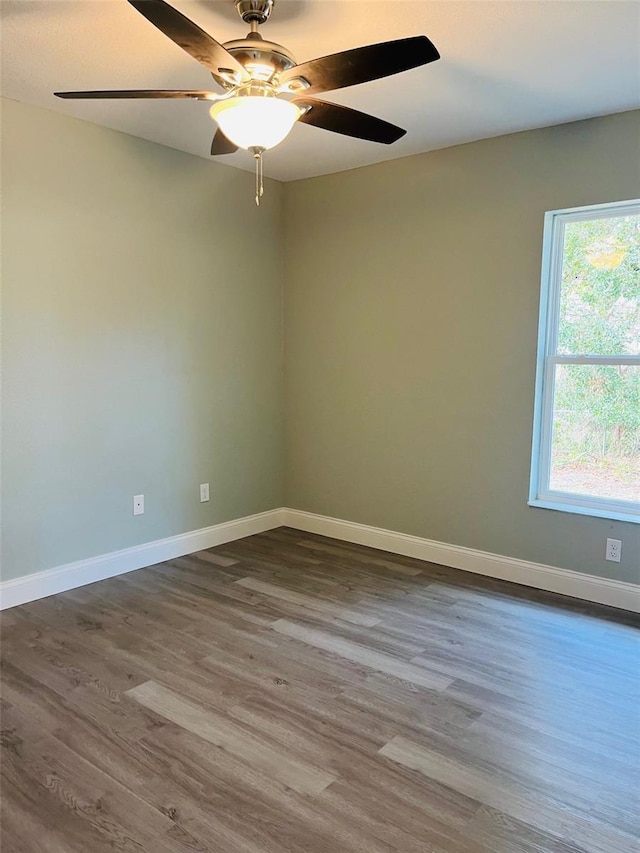 1329 Tom Watson Rd, Lakeland, FL 33801 - empty room with dark wood finished floors, baseboards, and ceiling fan